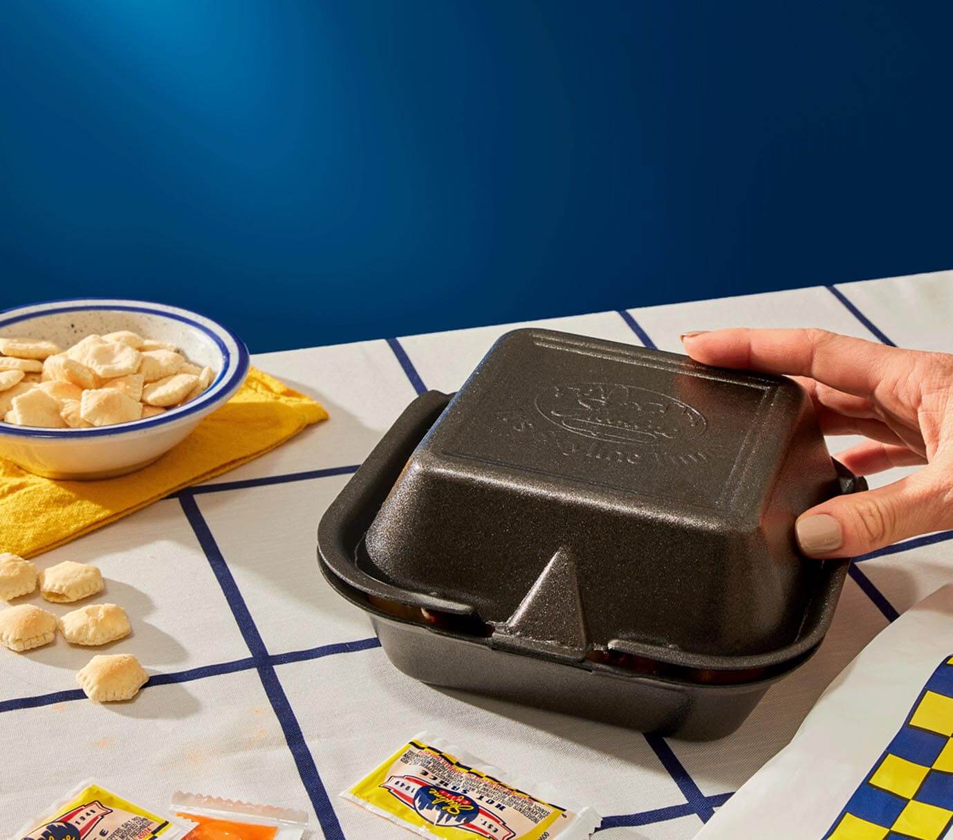 Hand opening black small takeout box