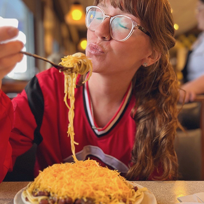 Woman eating noodles at skyline