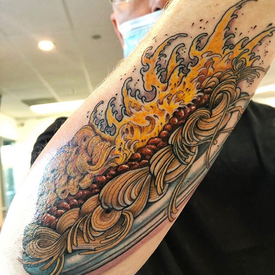 Tattoo of a skyline way on a mans arm