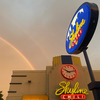 Rainbow in the sky behind a Skyline Chili building