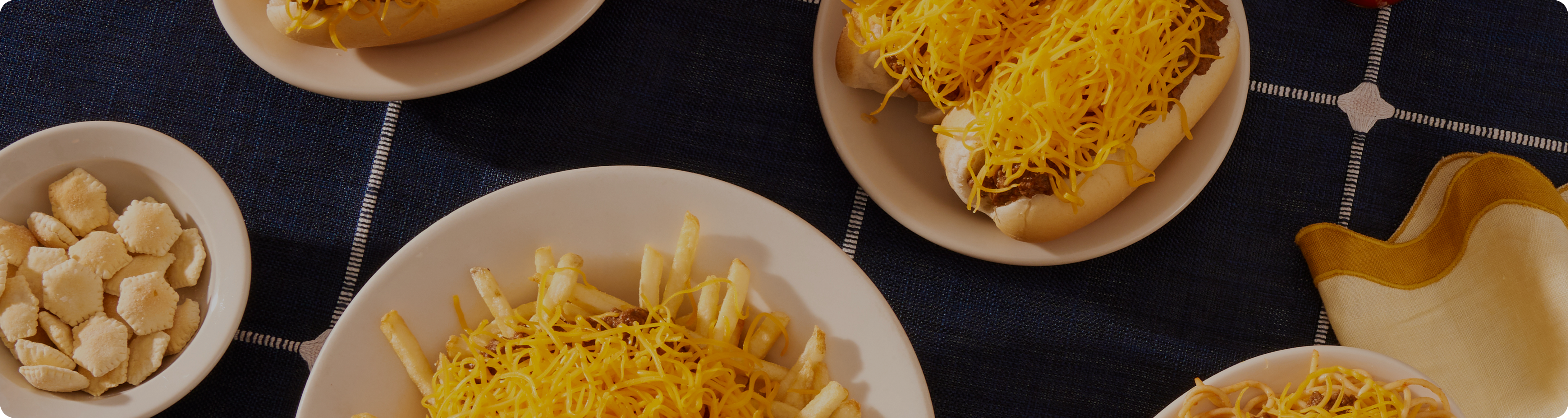 Top down view of table with navy table cloth and various skyline dishes on the table